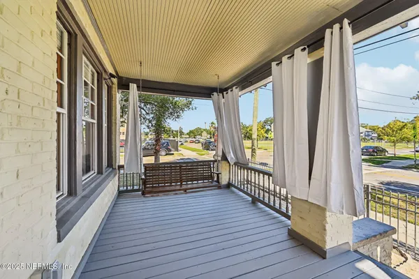 a view of balcony with wooden floor