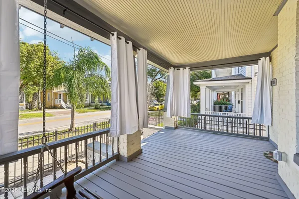a view of outdoor space with wooden floor and windows