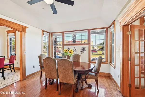 a view of a dining room with furniture window and wooden floor