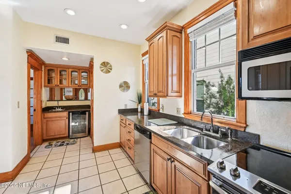 a kitchen with stainless steel appliances a sink stove and refrigerator