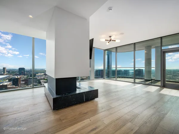 a living room with couch tv and a floor to ceiling window