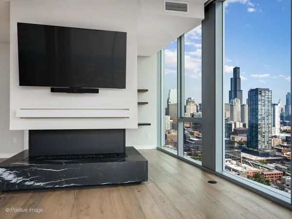 a living room with a fireplace and a flat screen tv