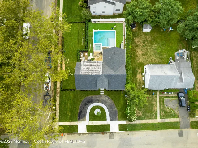 front view of a brick house with a yard