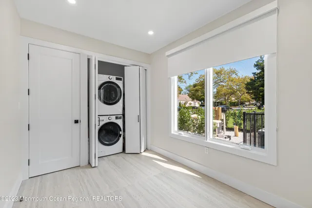 a view of a bedroom with washer and dryer