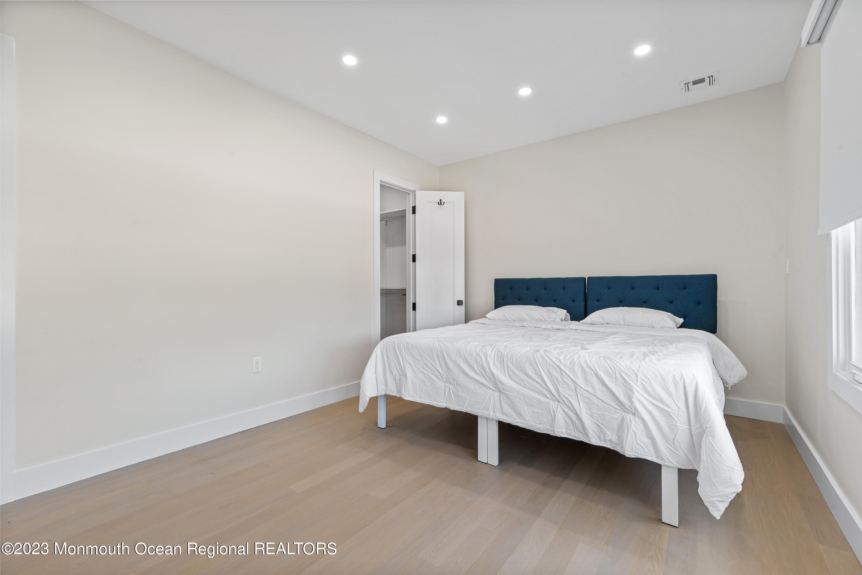 929 Van Ct Avenue Long Branch, NJ 07740 - Photo 18 of 37 a spacious bedroom with a bed and a night stand