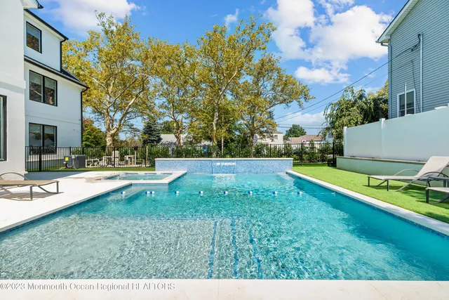 a view of a house with swimming pool and sitting area