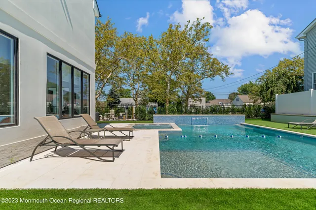 a view of backyard of house with seating space