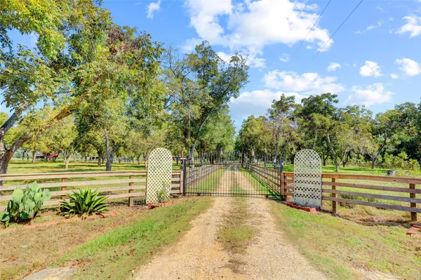 a view of a swimming pool with an outdoor seating and a yard