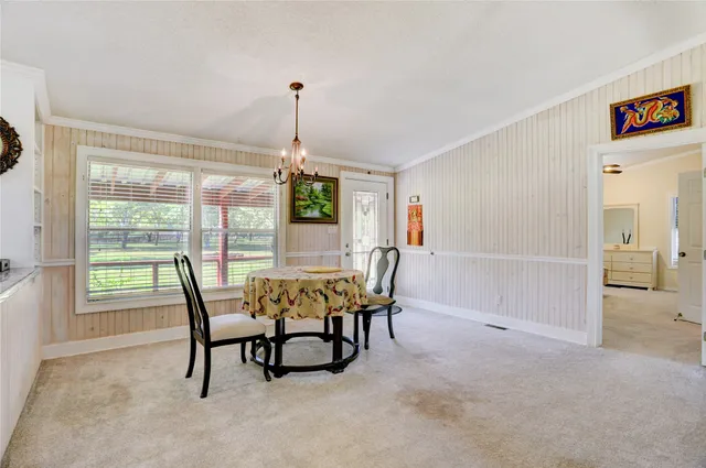a dining room with furniture and window