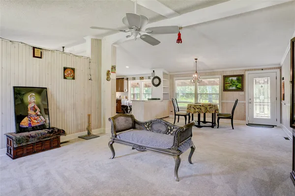 a living room with furniture and a floor to ceiling window