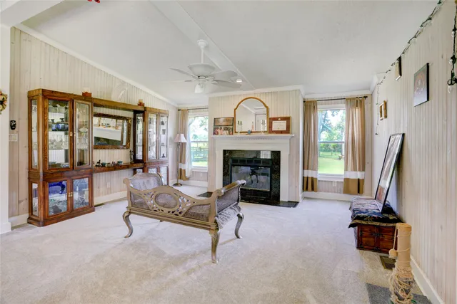 a living room with furniture large window and a fireplace