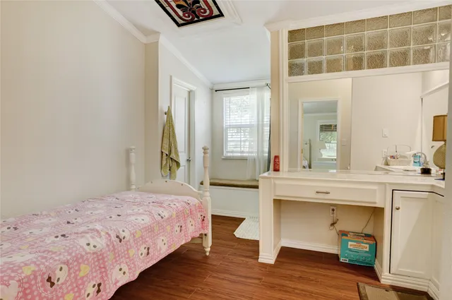 a spacious bedroom with a bed and a table in it