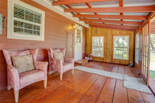 a view of a room with furniture and wooden floor