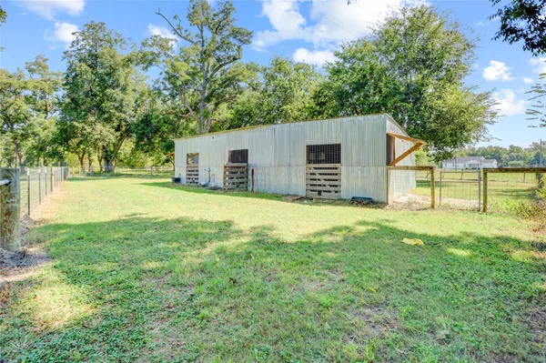 a house with huge green field in front of it