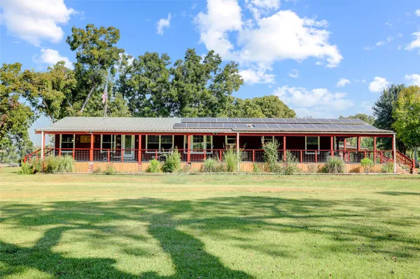 a front view of a house with a big yard