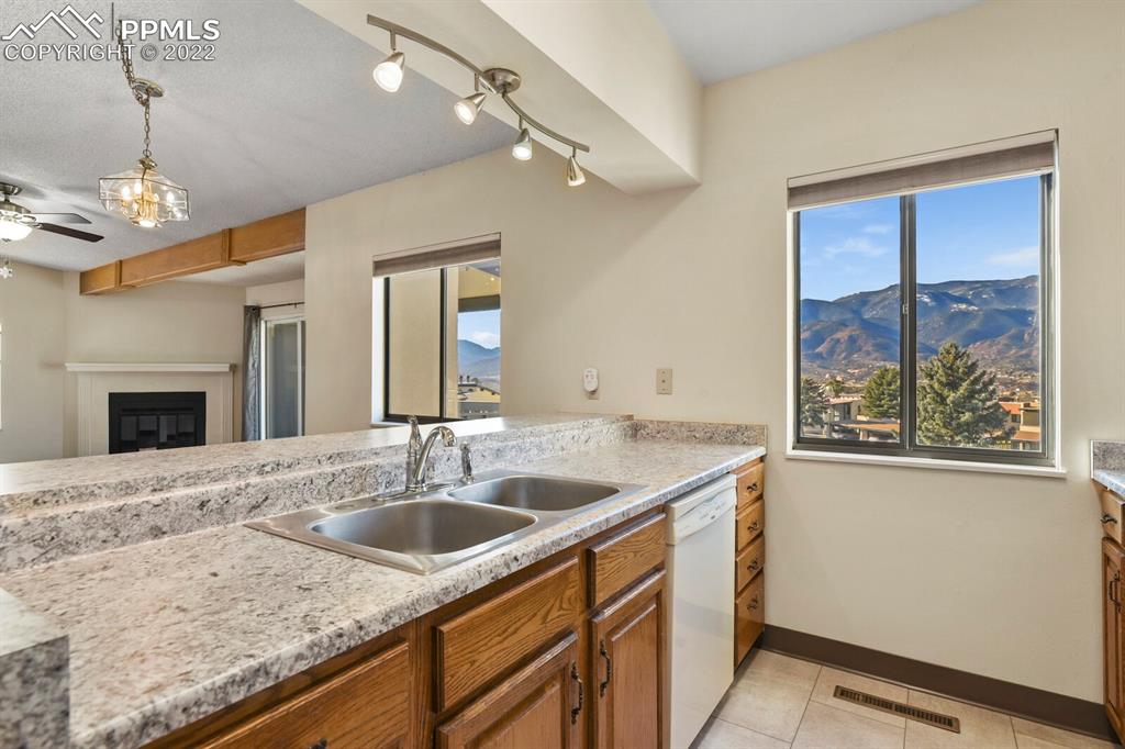 1130 Fontmore Road, Unit C Colorado Springs, CO 80904 - Photo 13 of 27 a bathroom with a granite countertop sink a large mirror and a window