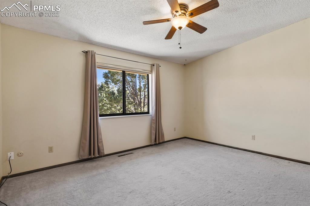 1130 Fontmore Road, Unit C Colorado Springs, CO 80904 - Photo 20 of 27 an empty room with windows and fan