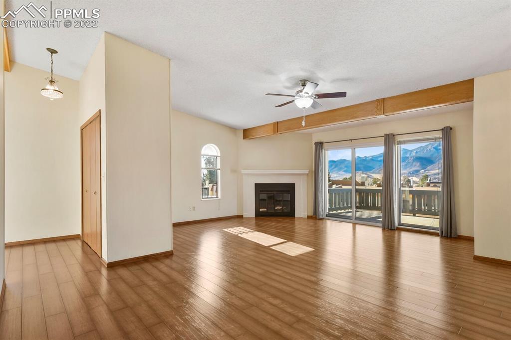 1130 Fontmore Road, Unit C Colorado Springs, CO 80904 - Photo 6 of 27 a view of an empty room with a fireplace and wooden floor