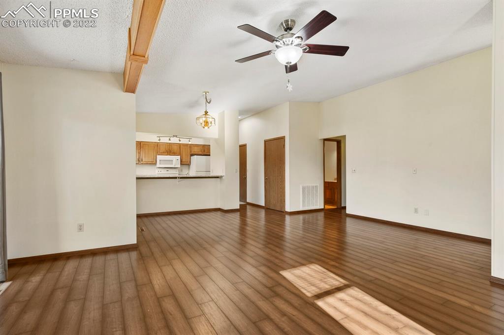 1130 Fontmore Road, Unit C Colorado Springs, CO 80904 - Photo 8 of 27 a view of an empty room with a window and wooden floor