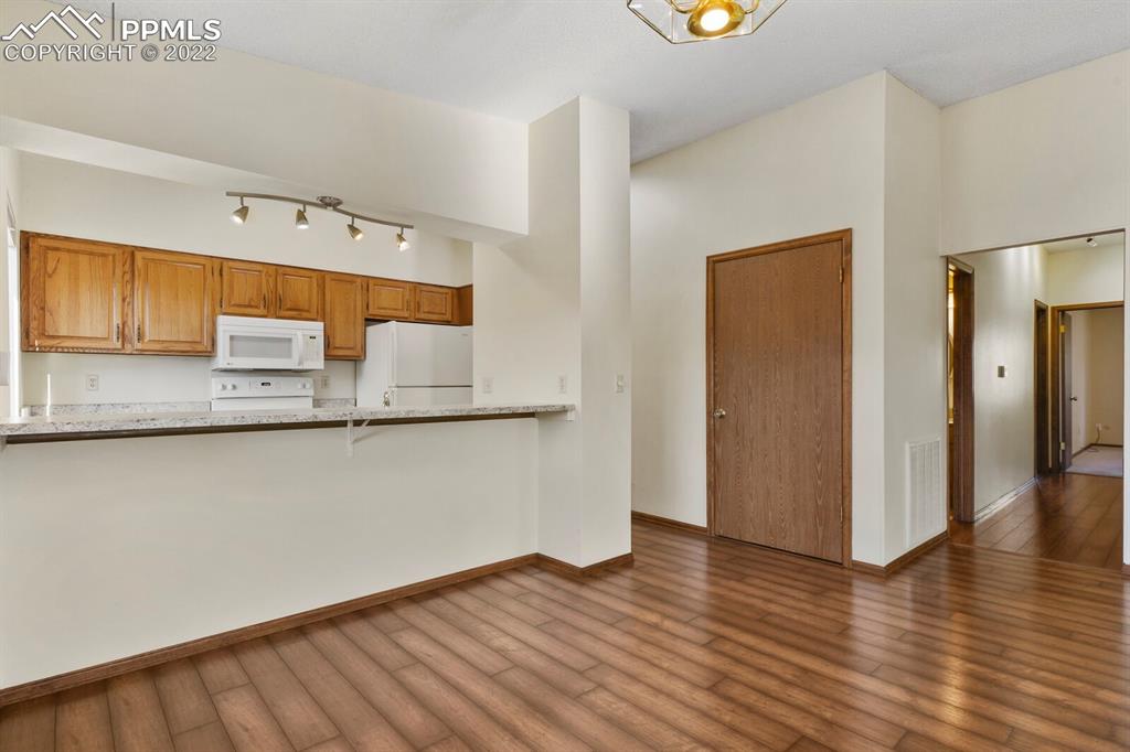 1130 Fontmore Road, Unit C Colorado Springs, CO 80904 - Photo 10 of 27 a kitchen with stainless steel appliances granite countertop a refrigerator and a microwave