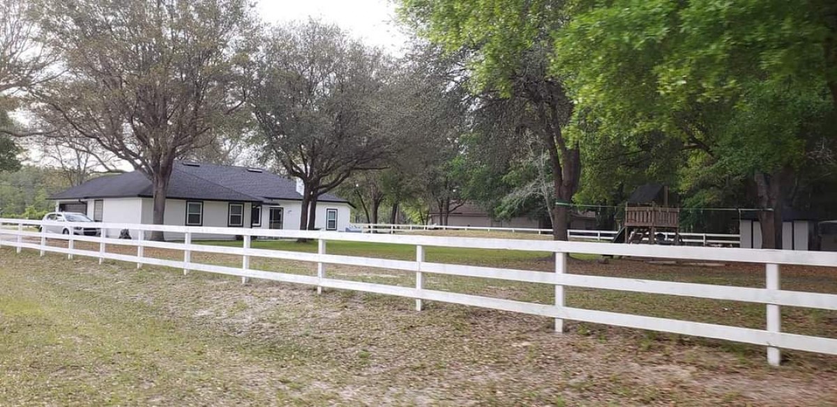 96414 Chester Road Yulee, FL 32097 - Photo 2 of 13 a view of a house with a yard and large trees
