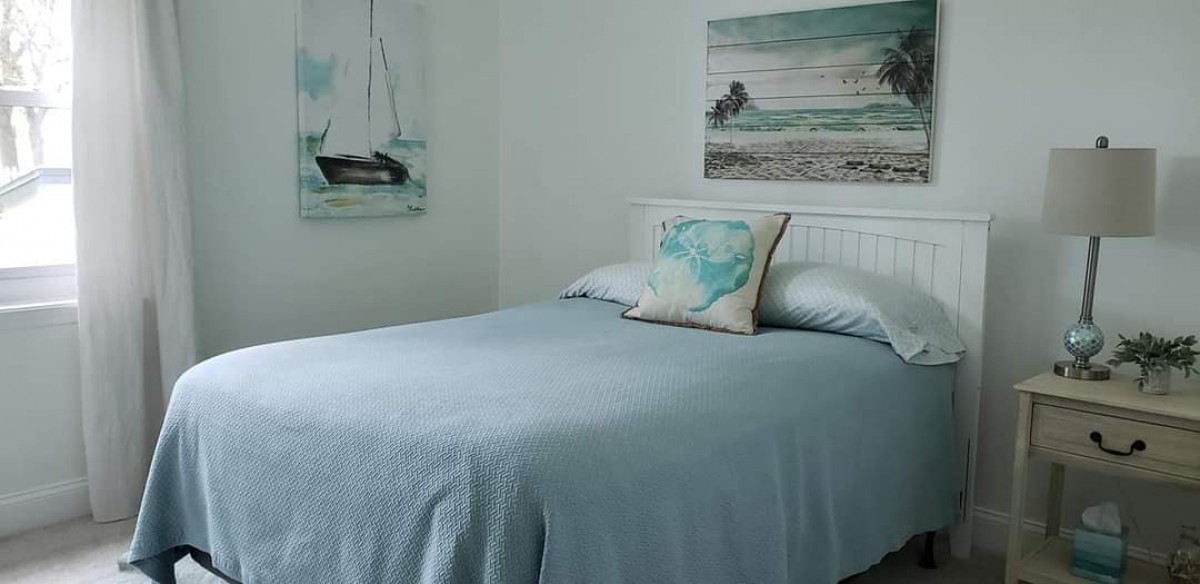 96414 Chester Road Yulee, FL 32097 - Photo 10 of 13 a bed sitting in a bedroom next to a window