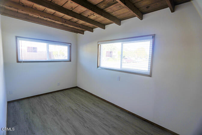 3661 Sunset Lane Oxnard, CA 93035 - Photo 11 of 14 a view of an empty room with wooden floor and a window