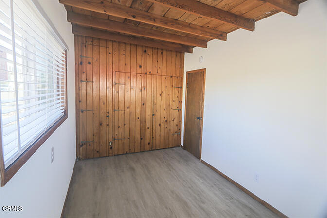 3661 Sunset Lane Oxnard, CA 93035 - Photo 12 of 14 a view of an empty room with wooden floor and a window