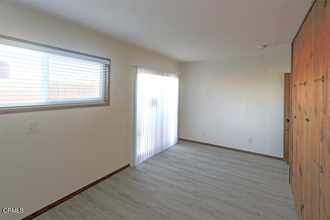 3661 Sunset Lane Oxnard, CA 93035 - Photo 13 of 14 an empty room with wooden floor and windows