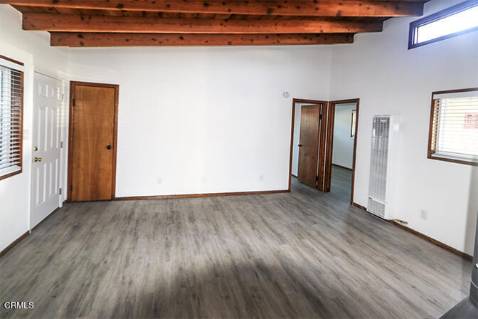 3661 Sunset Lane Oxnard, CA 93035 - Photo 6 of 14 an empty room with wooden floor and windows