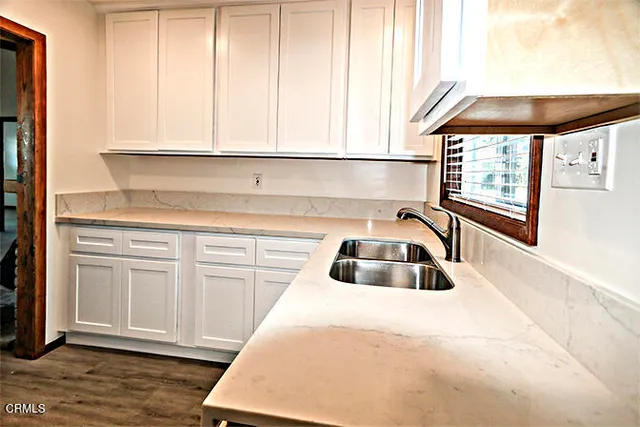 a kitchen with a sink and cabinets