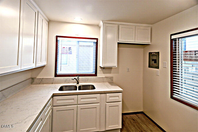 3661 Sunset Lane Oxnard, CA 93035 - Photo 9 of 14 a kitchen with kitchen island a sink cabinets and window