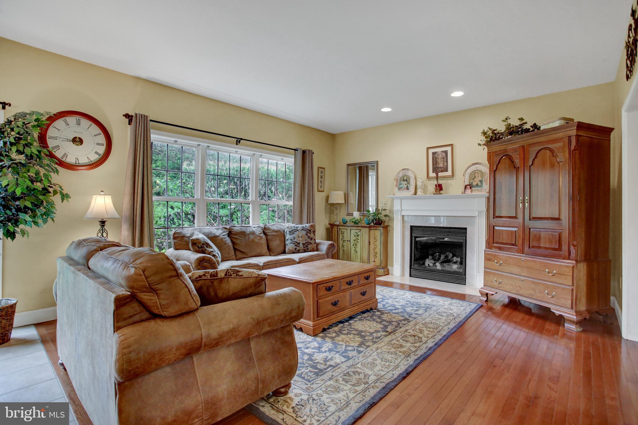 765 Habecker Church Road Washington Boro, PA 17582 - Photo 8 of 29 a living room with furniture a fireplace and a table