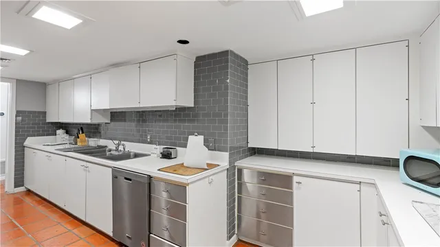 a kitchen with kitchen island a counter and a refrigerator