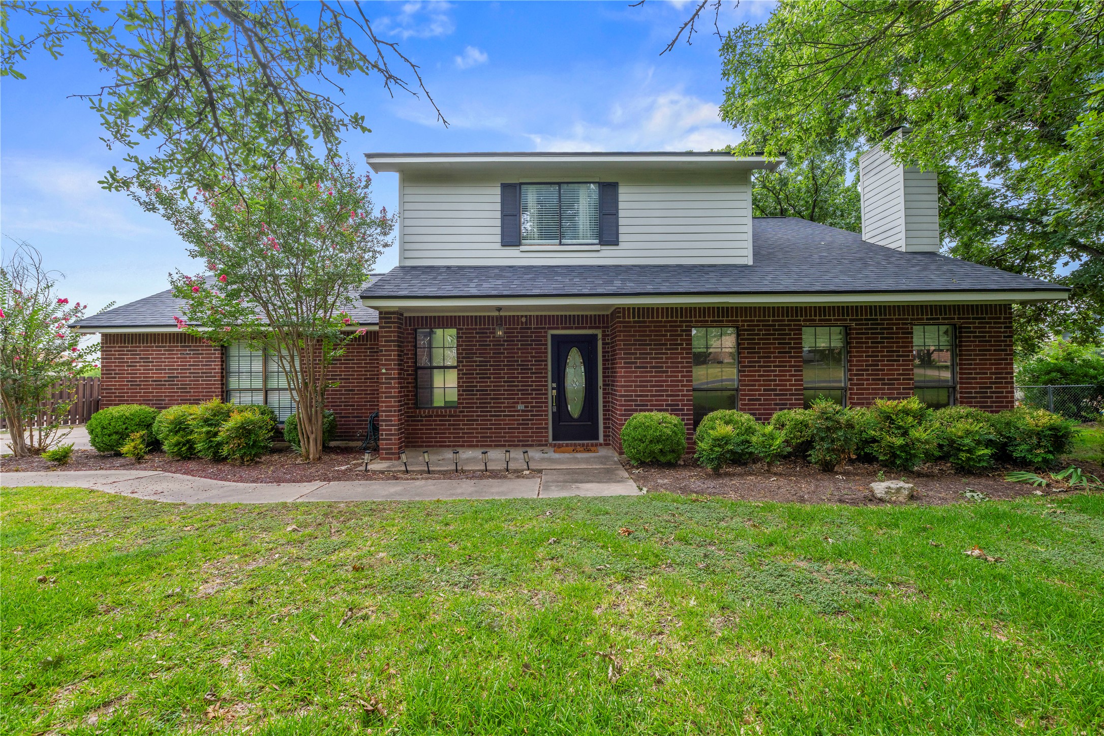 1329 Quail Ravine Round Rock, TX 78664 - Photo 1 of 39 A classic brick and siding exterior stands surrounded by mature trees and manicured shrubbery.