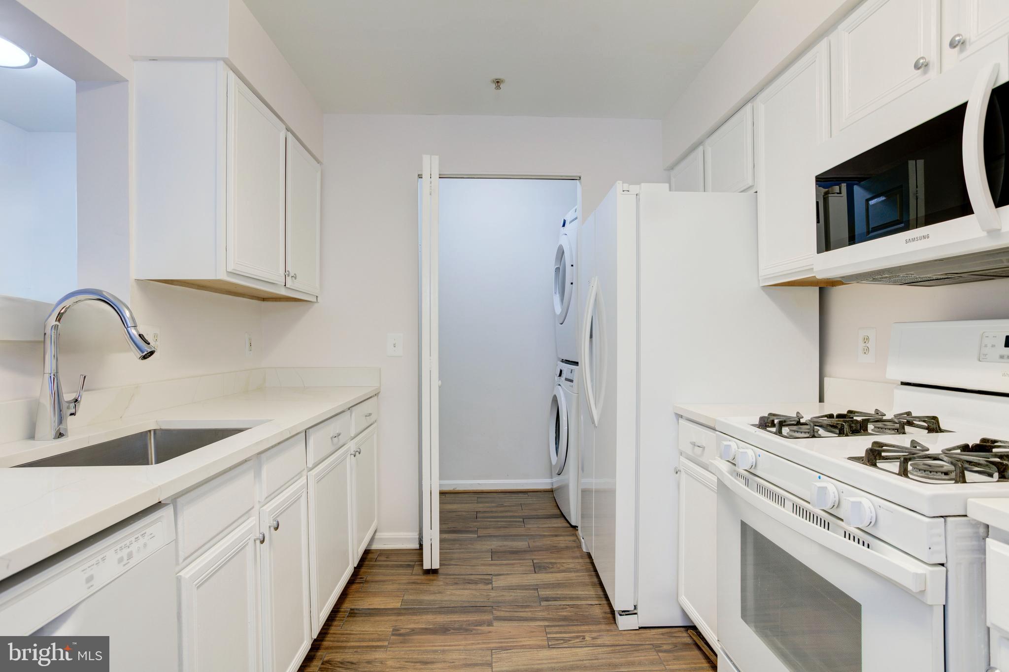a kitchen with stainless steel appliances a white stove top oven and refrigerator