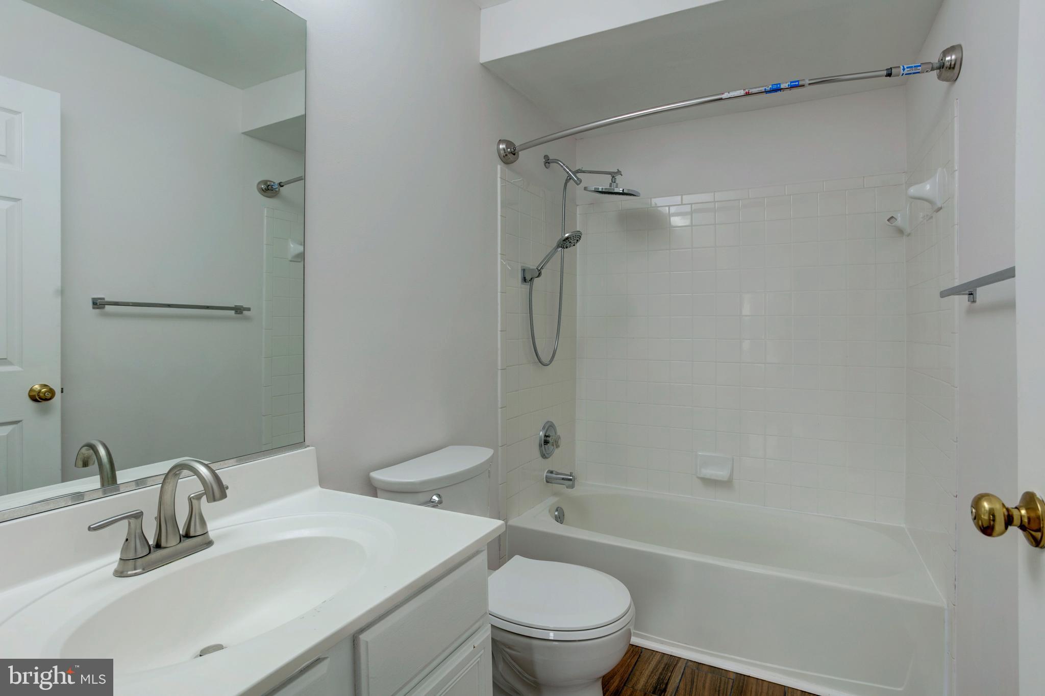 14174 Cuddy Loop, Unit 204 Woodbridge, VA 22193 - Photo 17 of 24 a bathroom with a sink toilet and shower
