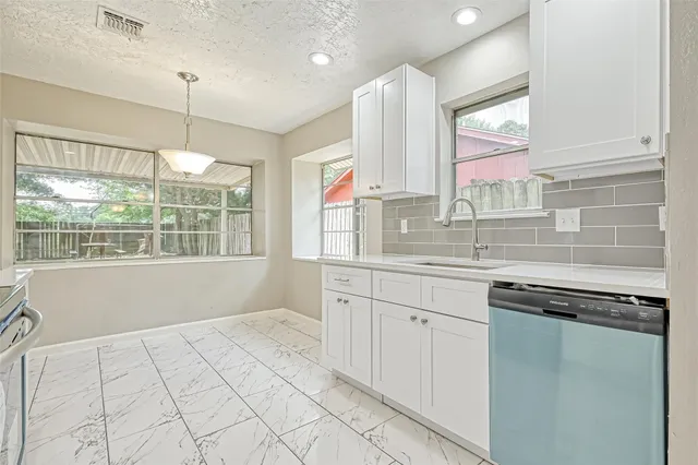 a kitchen with stainless steel appliances granite countertop a stove a microwave and a sink