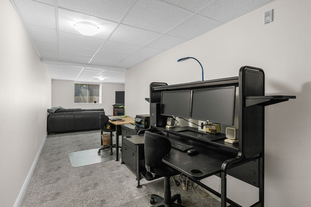 116 Grey Hawk Drive, Unit 116 Mashpee, MA 02649 - Photo 26 of 41 a living room with furniture and a flat screen tv