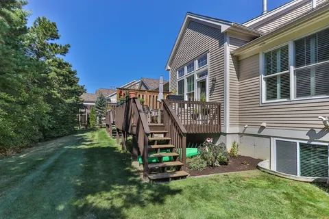 a view of a house with a yard and deck