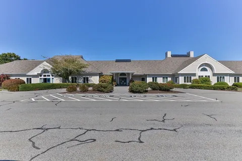 a front view of a building with a garden