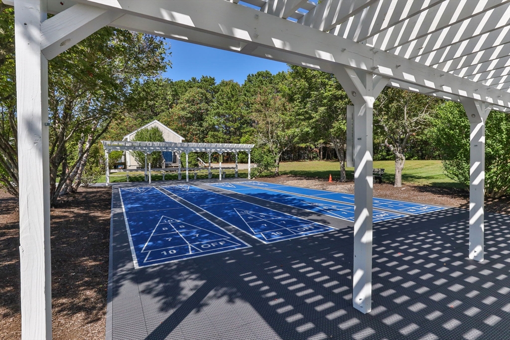 116 Grey Hawk Drive, Unit 116 Mashpee, MA 02649 - Photo 36 of 41 a view of a swimming pool with a porch