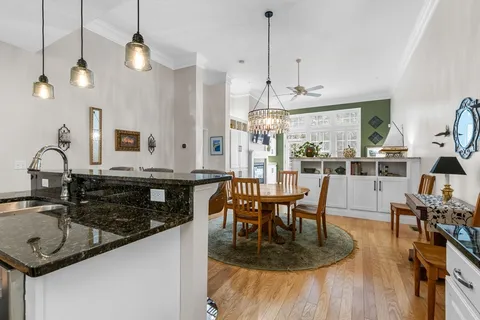 a kitchen with stainless steel appliances granite countertop a stove a sink a microwave a refrigerator and cabinets