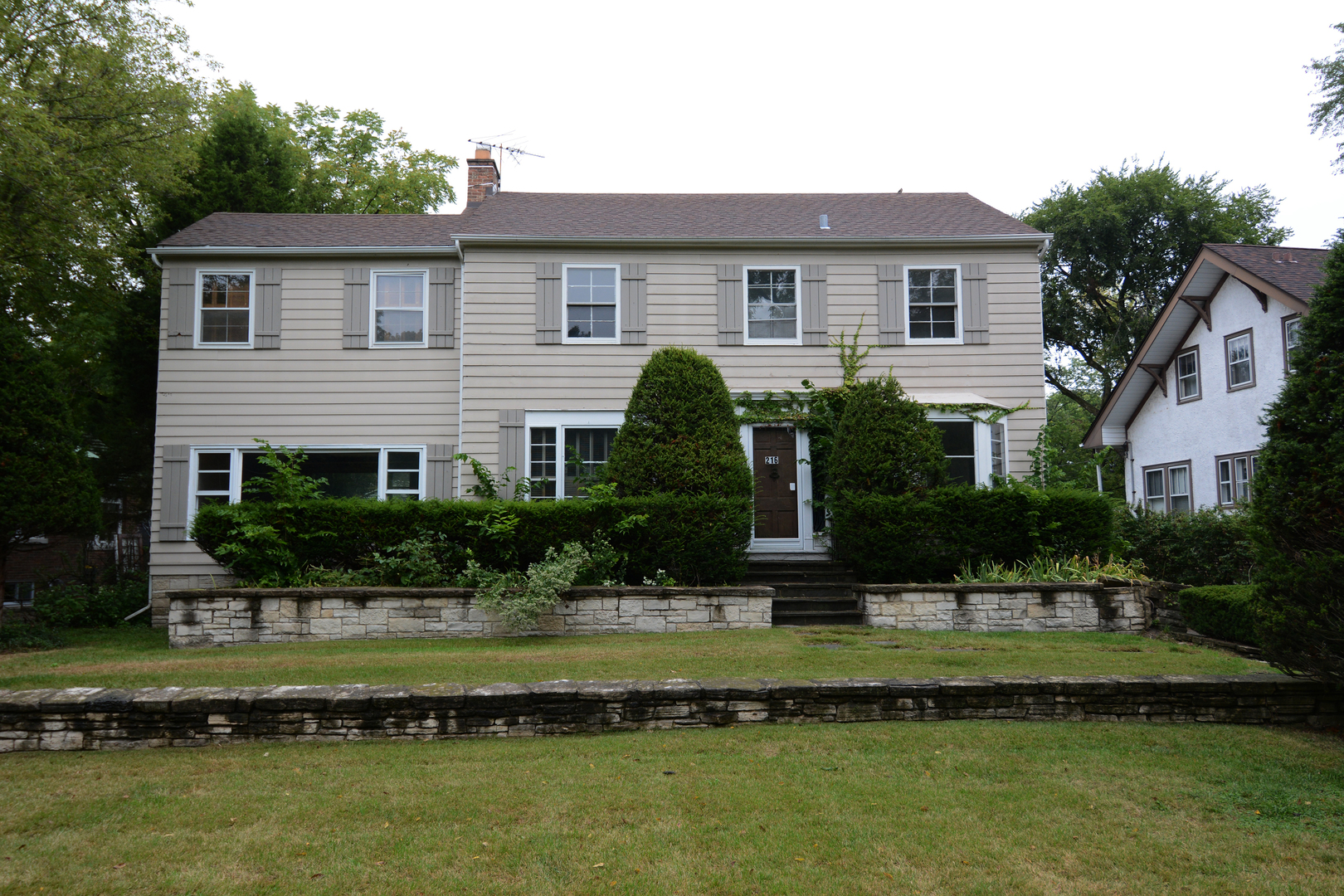 216 Blackhawk Road Riverside, IL 60546 - Photo 21 of 27 a front view of a house with a yard and potted plants