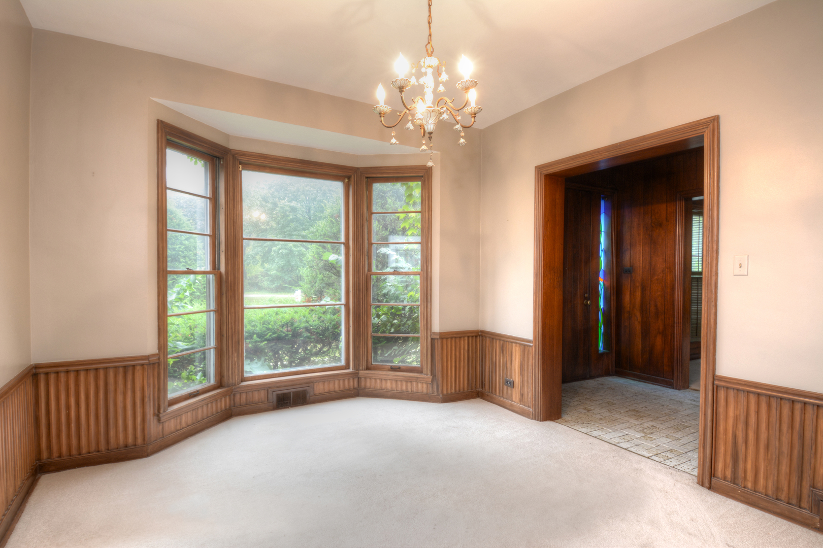 216 Blackhawk Road Riverside, IL 60546 - Photo 5 of 27 a view of an empty room with a window and chandelier