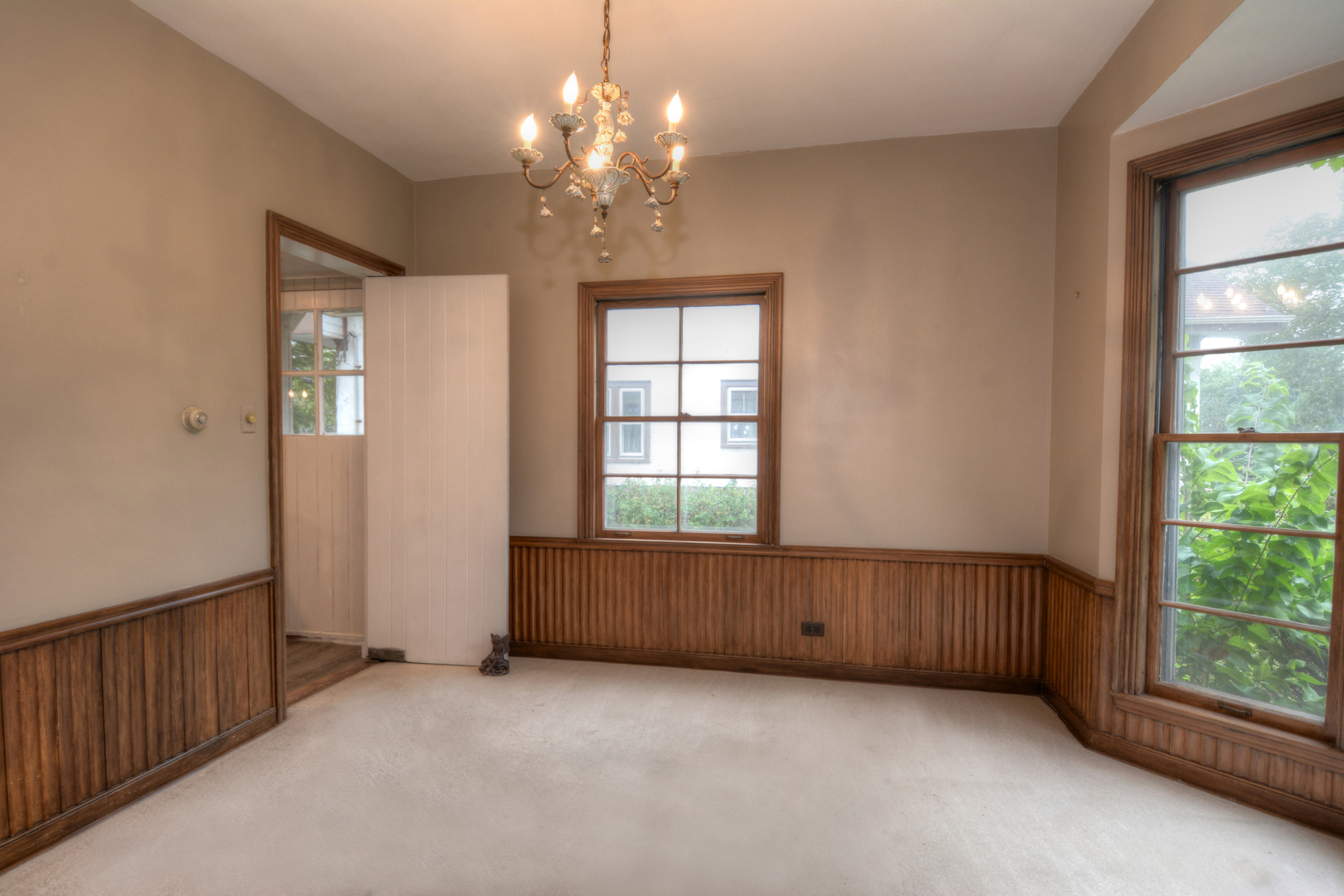 216 Blackhawk Road Riverside, IL 60546 - Photo 6 of 27 an empty room with windows and chandelier