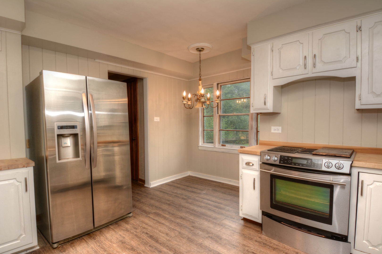 216 Blackhawk Road Riverside, IL 60546 - Photo 7 of 27 a kitchen with granite countertop wooden floors and stainless steel appliances
