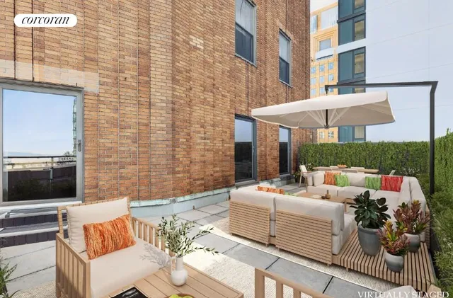 a view of a patio with couches table and chairs under an umbrella