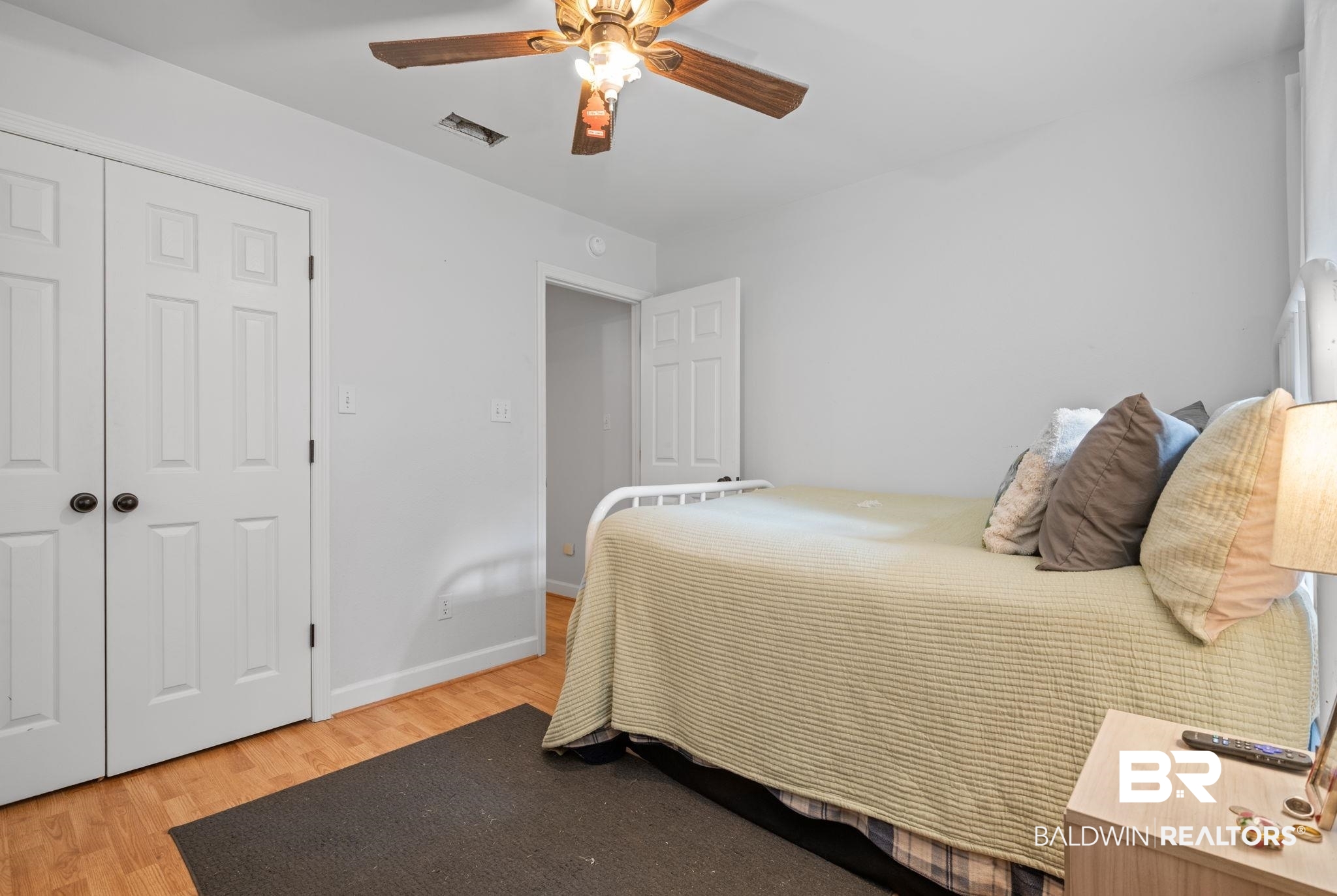 5936 Lundy Road Theodore, AL 36582 - Photo 17 of 32 Room featuring wood-finish flooring, light grey walls, and a white six-panel bifold closet door