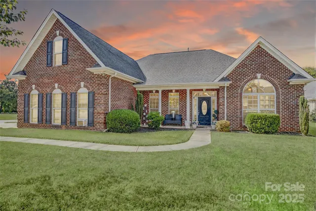 a front view of a house with a yard and porch